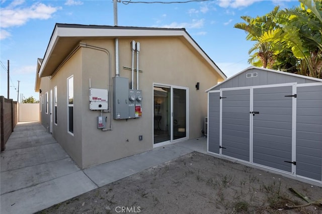 8491 Emerado Pl, Westminster, CA 92683 - back of property featuring a storage unit, fence, a patio area, an outdoor structure, and stucco siding
