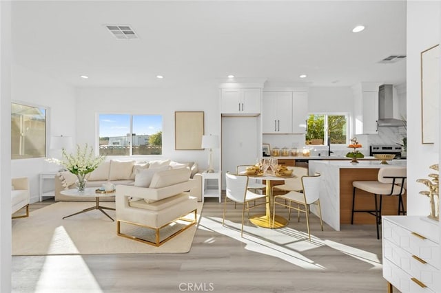 8491 Emerado Pl, Westminster, CA 92683 - living area with light wood-style floors, visible vents, and recessed lighting