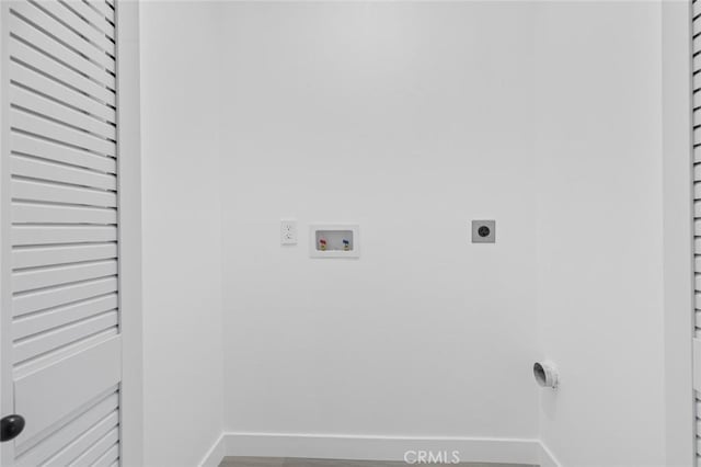 8491 Emerado Pl, Westminster, CA 92683 - washroom with laundry area, wood finished floors, hookup for an electric dryer, baseboards, and washer hookup