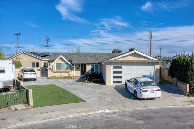 8491 Emerado Pl, Westminster, CA 92683 - ranch-style home featuring fence, a front lawn, driveway, and roof mounted solar panels