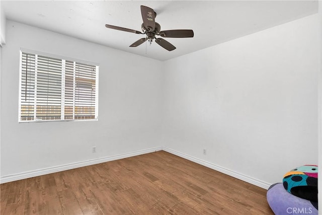 13564 Sylvan Oaks Rd, Victorville, CA 92392 - empty room featuring wood finished floors, baseboards, and a ceiling fan