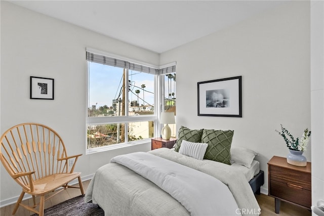 5643 Cielo Way, Los Angeles, CA 90028 - bedroom featuring multiple windows, baseboards, and wood finished floors