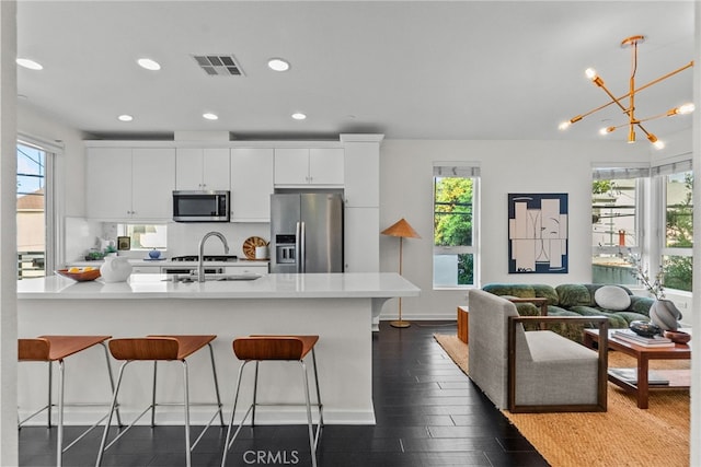 5643 Cielo Way, Los Angeles, CA 90028 - kitchen with appliances with stainless steel finishes, a kitchen bar, healthy amount of natural light, and recessed lighting