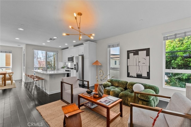 5643 Cielo Way, Los Angeles, CA 90028 - living area with recessed lighting, dark wood-style flooring, baseboards, and a chandelier