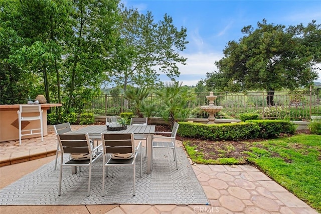 view of patio with fence and outdoor dining area