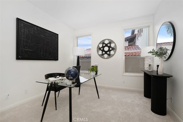 office space featuring baseboards, plenty of natural light, and carpet floors