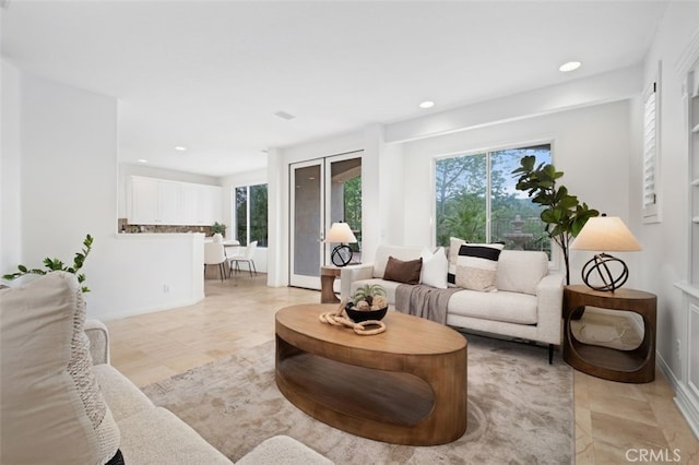 living room featuring baseboards and recessed lighting