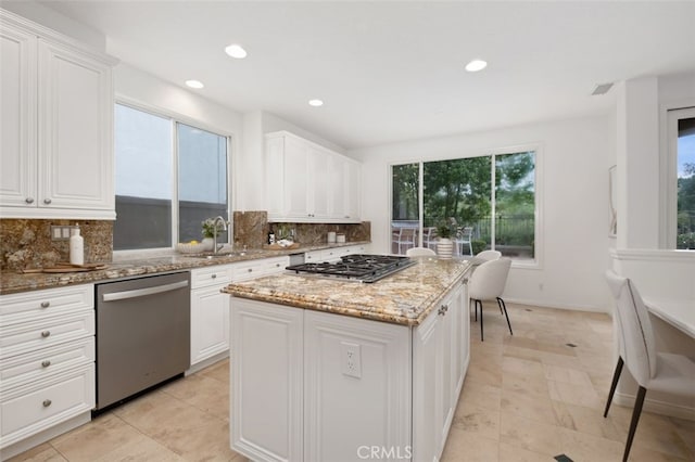 kitchen featuring backsplash, plenty of natural light, and stainless steel appliances