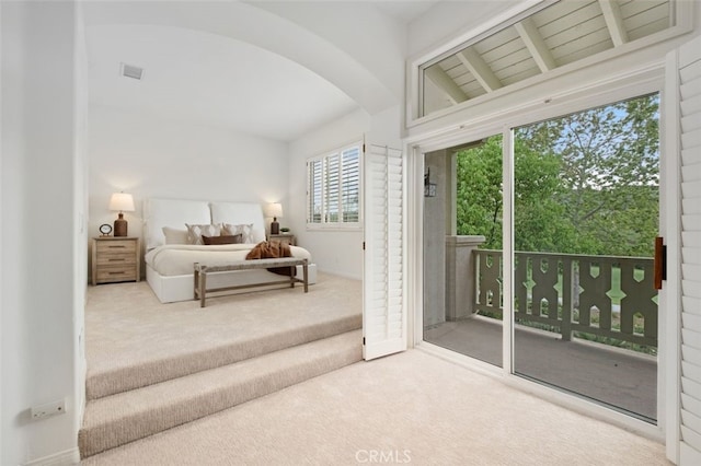 bedroom with visible vents, arched walkways, access to outside, vaulted ceiling with beams, and carpet flooring