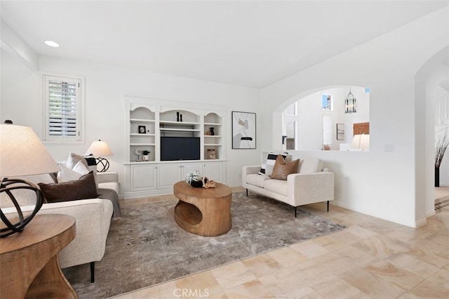 living room featuring arched walkways