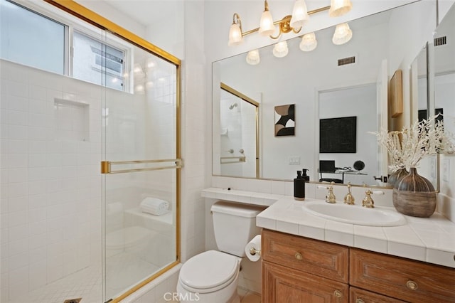 full bathroom with vanity, visible vents, a stall shower, and toilet
