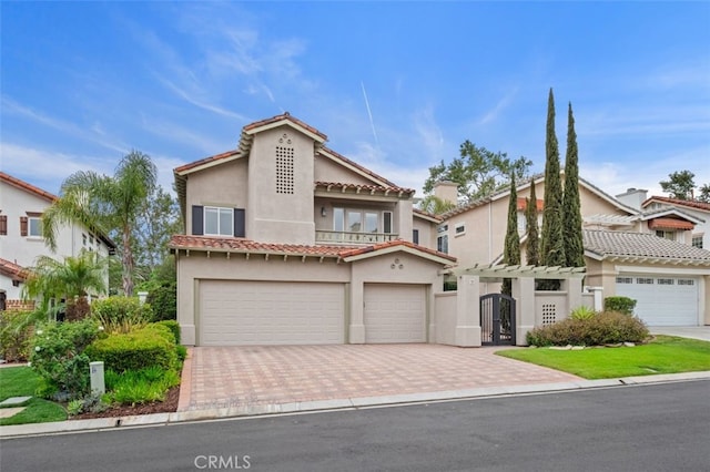 view of front of house with stucco siding, decorative driveway, french doors, and a tile roof
