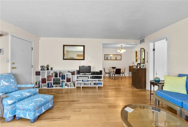 266 N 14th St, Banning, CA 92220 - living area with light wood-style floors and a chandelier