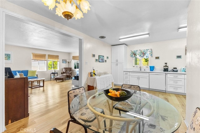 266 N 14th St, Banning, CA 92220 - dining space featuring light wood-style flooring and a chandelier