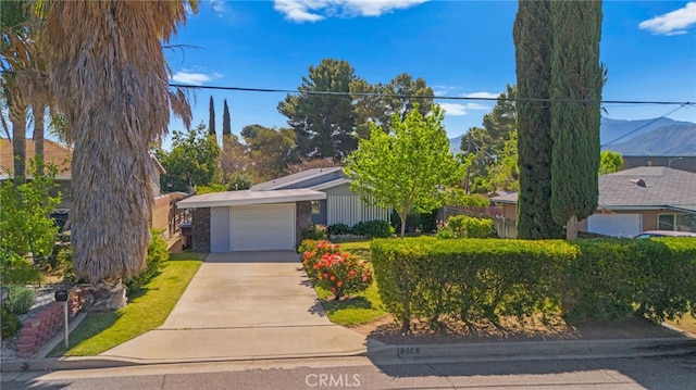 266 N 14th St, Banning, CA 92220 - view of front of property featuring driveway, a garage, and stone siding