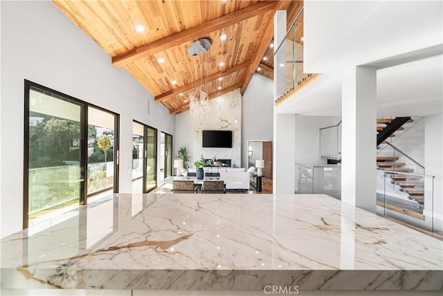 living room with high vaulted ceiling, beamed ceiling, recessed lighting, wooden ceiling, and stairs
