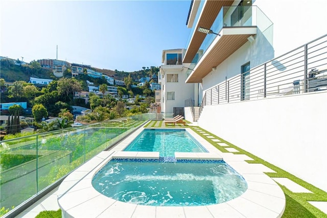 view of swimming pool with a pool with connected hot tub