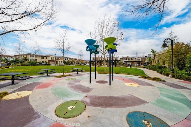 view of property's community featuring a lawn and a residential view
