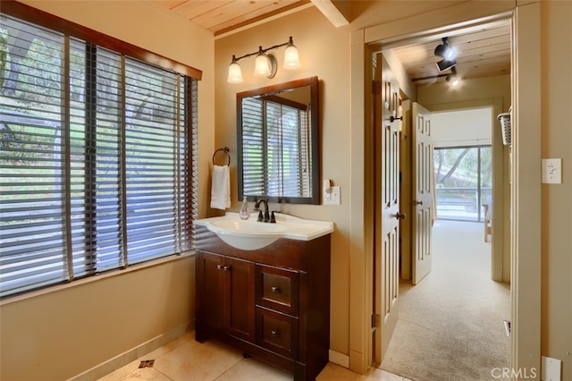bathroom featuring baseboards, vanity, and wooden ceiling