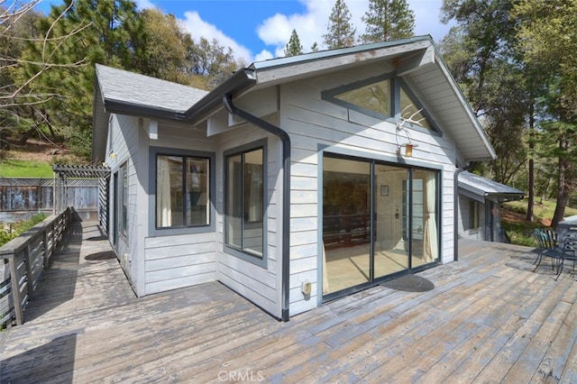 view of side of property with fence and a deck