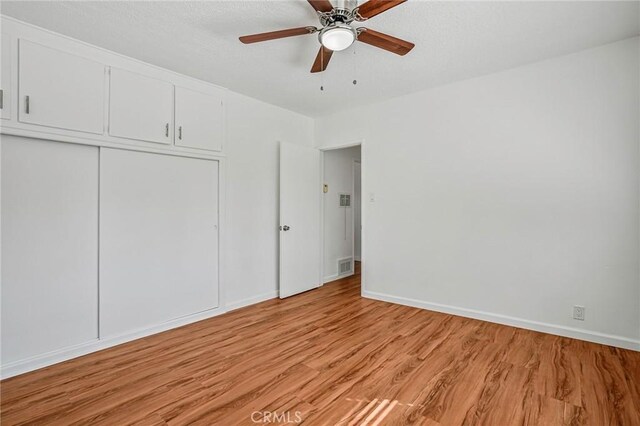 1101 E Ocean Blvd Unit 14, Long Beach, CA 90802 - unfurnished bedroom with light wood finished floors, a closet, visible vents, and baseboards