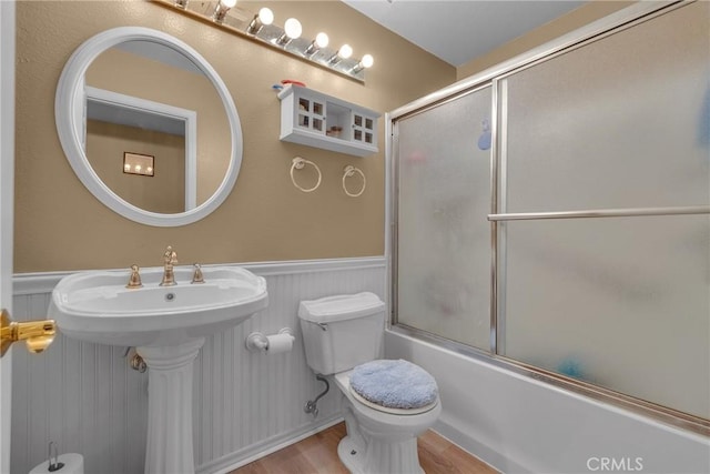 25351 Chicago Ave, Hemet, CA 92544 - full bath with toilet, a wainscoted wall, wood finished floors, and shower / bath combination with glass door