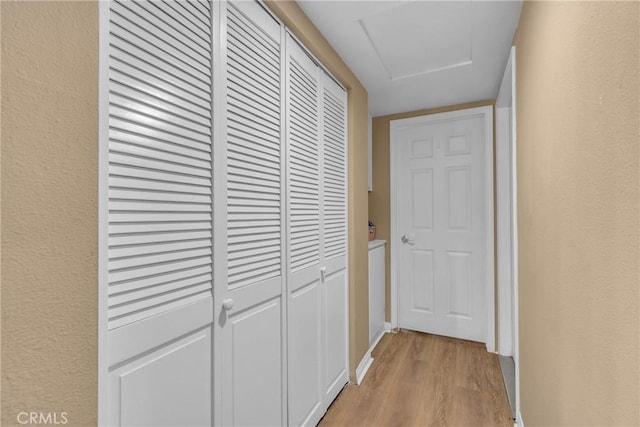 25351 Chicago Ave, Hemet, CA 92544 - hallway featuring light wood finished floors, a textured wall, and baseboards