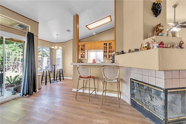 25351 Chicago Ave, Hemet, CA 92544 - kitchen with light wood finished floors, glass insert cabinets, lofted ceiling, and a wealth of natural light