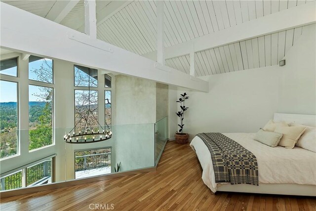 27637 St Bernard Ln, Lake Arrowhead, CA 92352 - bedroom with high vaulted ceiling, hardwood / wood-style flooring, beam ceiling, and a notable chandelier
