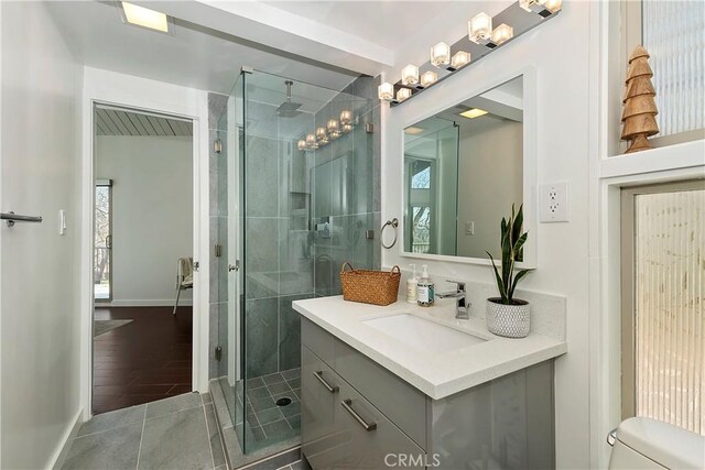 27637 St Bernard Ln, Lake Arrowhead, CA 92352 - full bathroom with vanity, toilet, baseboards, tile patterned floors, and a stall shower