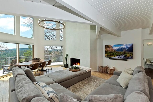 27637 St Bernard Ln, Lake Arrowhead, CA 92352 - living room featuring a high end fireplace, plenty of natural light, beam ceiling, and wood finished floors