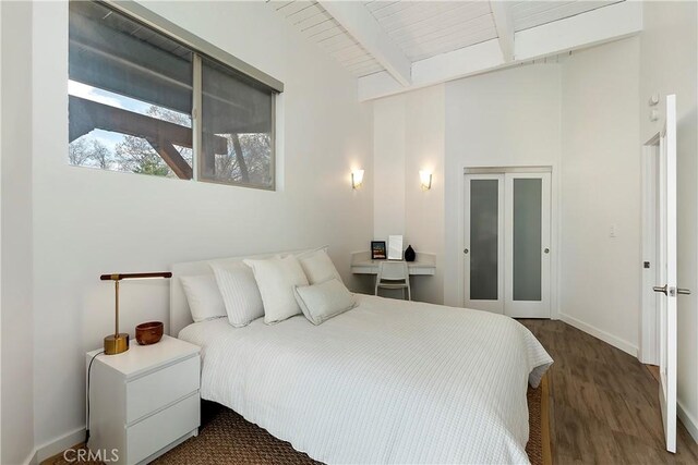 27637 St Bernard Ln, Lake Arrowhead, CA 92352 - bedroom with baseboards, beamed ceiling, wood finished floors, and a high ceiling