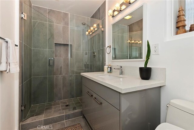27637 St Bernard Ln, Lake Arrowhead, CA 92352 - bathroom featuring vanity, a stall shower, and toilet