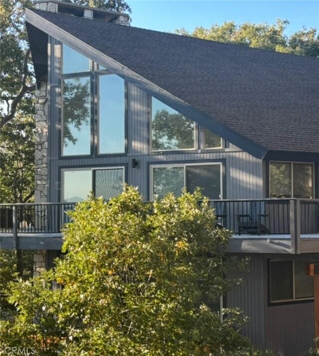 27637 St Bernard Ln, Lake Arrowhead, CA 92352 - view of side of home featuring a balcony and a shingled roof