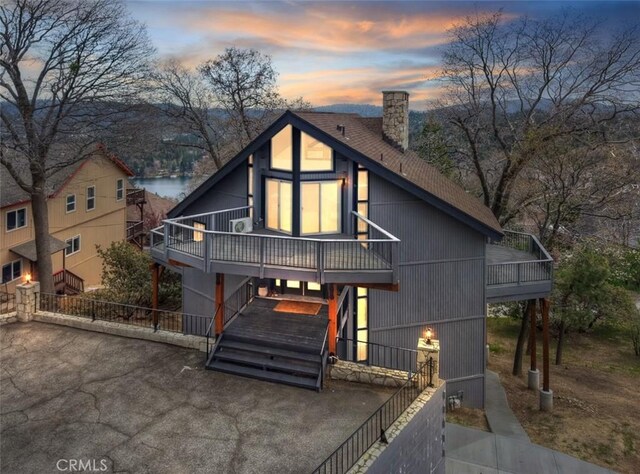 27637 St Bernard Ln, Lake Arrowhead, CA 92352 - chalet / cabin with a chimney, a deck with water view, a shingled roof, and fence