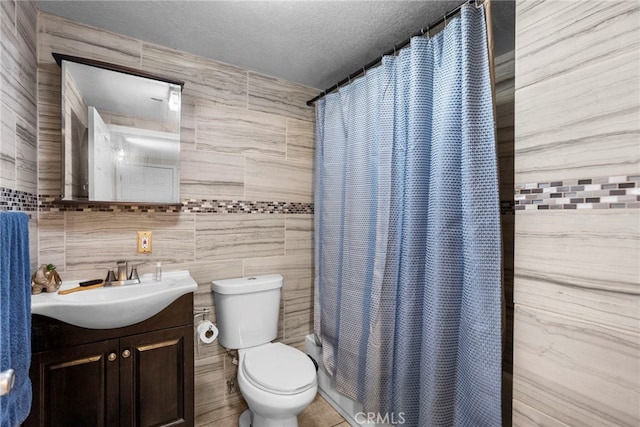2619 Trinity St, Los Angeles, CA 90011 - bathroom featuring tile walls, vanity, toilet, and a textured ceiling