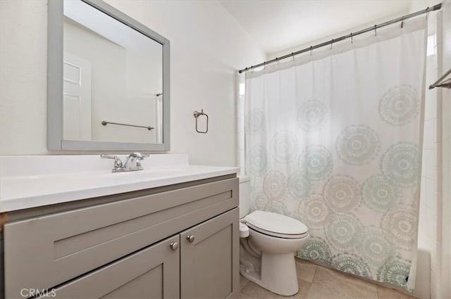 bathroom featuring toilet, shower / bath combo with shower curtain, tile patterned flooring, and vanity