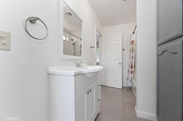 full bath with visible vents, baseboards, vanity, and shower / bath combination with curtain