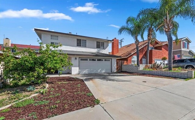 traditional home featuring concrete driveway and stucco siding