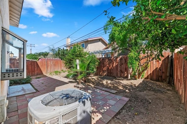 view of patio with a fenced backyard and cooling unit