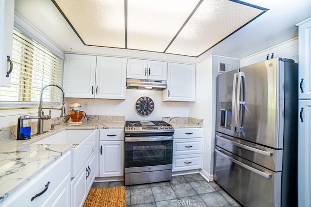 25176 Silent Creek Rd, Moreno Valley, CA 92553 - kitchen featuring appliances with stainless steel finishes, under cabinet range hood, white cabinetry, a sink, and light stone counters