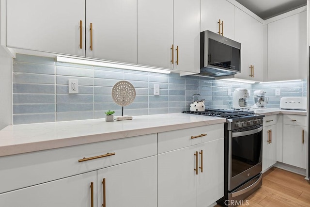 1707 W Bushell, Anaheim, CA 92805 - kitchen with tasteful backsplash, white cabinets, appliances with stainless steel finishes, light wood-style flooring, and light stone counters