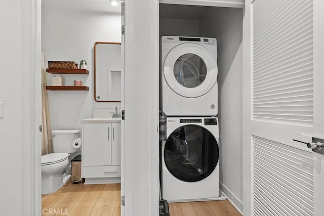 1707 W Bushell, Anaheim, CA 92805 - laundry room with laundry area, light wood-style floors, and stacked washer / drying machine