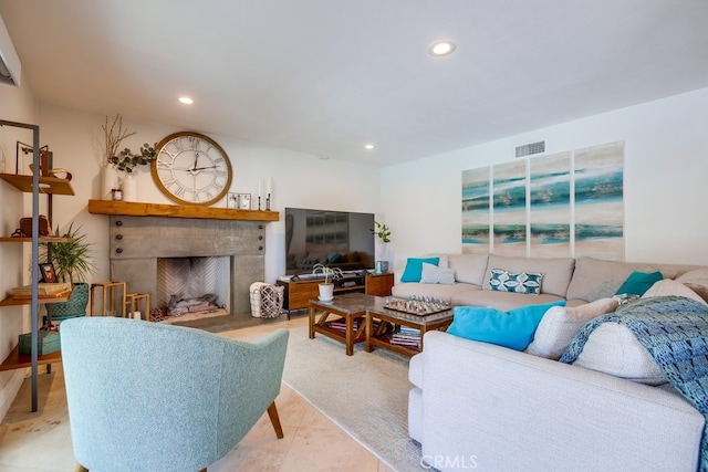 living area featuring recessed lighting, visible vents, and a fireplace