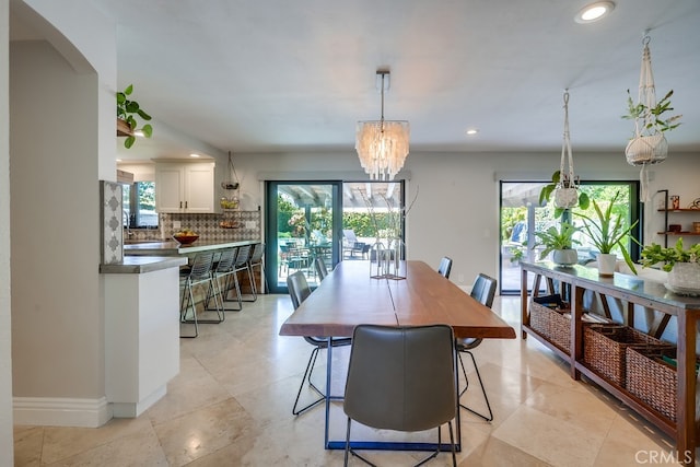 dining space featuring recessed lighting, a healthy amount of sunlight, and baseboards