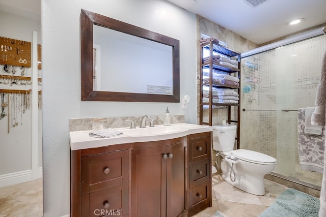full bathroom with toilet, vanity, and a stall shower
