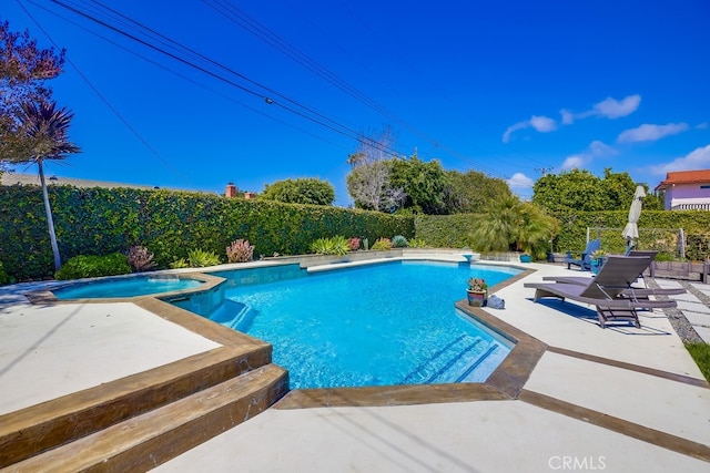 view of pool featuring a patio area, a fenced backyard, and a pool with connected hot tub