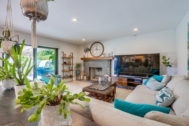 living room featuring a tiled fireplace and recessed lighting