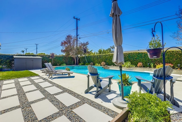 view of swimming pool with a fenced in pool, a fenced backyard, and a patio
