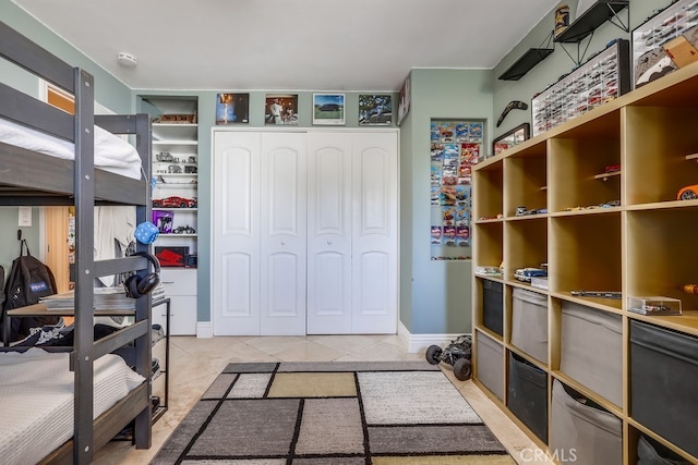 bedroom with a closet and light tile patterned flooring